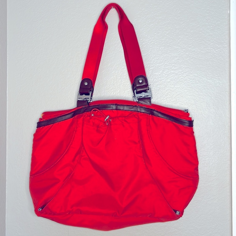 Baggallini bright orange with brown leather trim bag